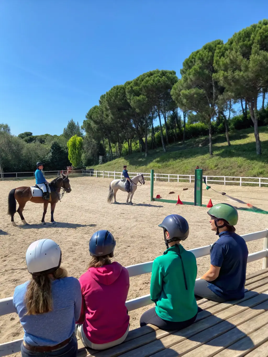 A photograph of a group of riders participating in a western riding clinic, focusing on horsemanship skills, set in a sunny outdoor arena at WESTERN ATTITUDE 19.